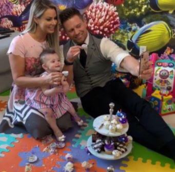 Monroe with her mom and dad at her nursery room